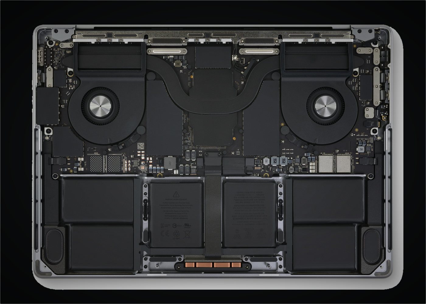 The internals of a 16-inch MacBook Pro, fans and battery cells exposed